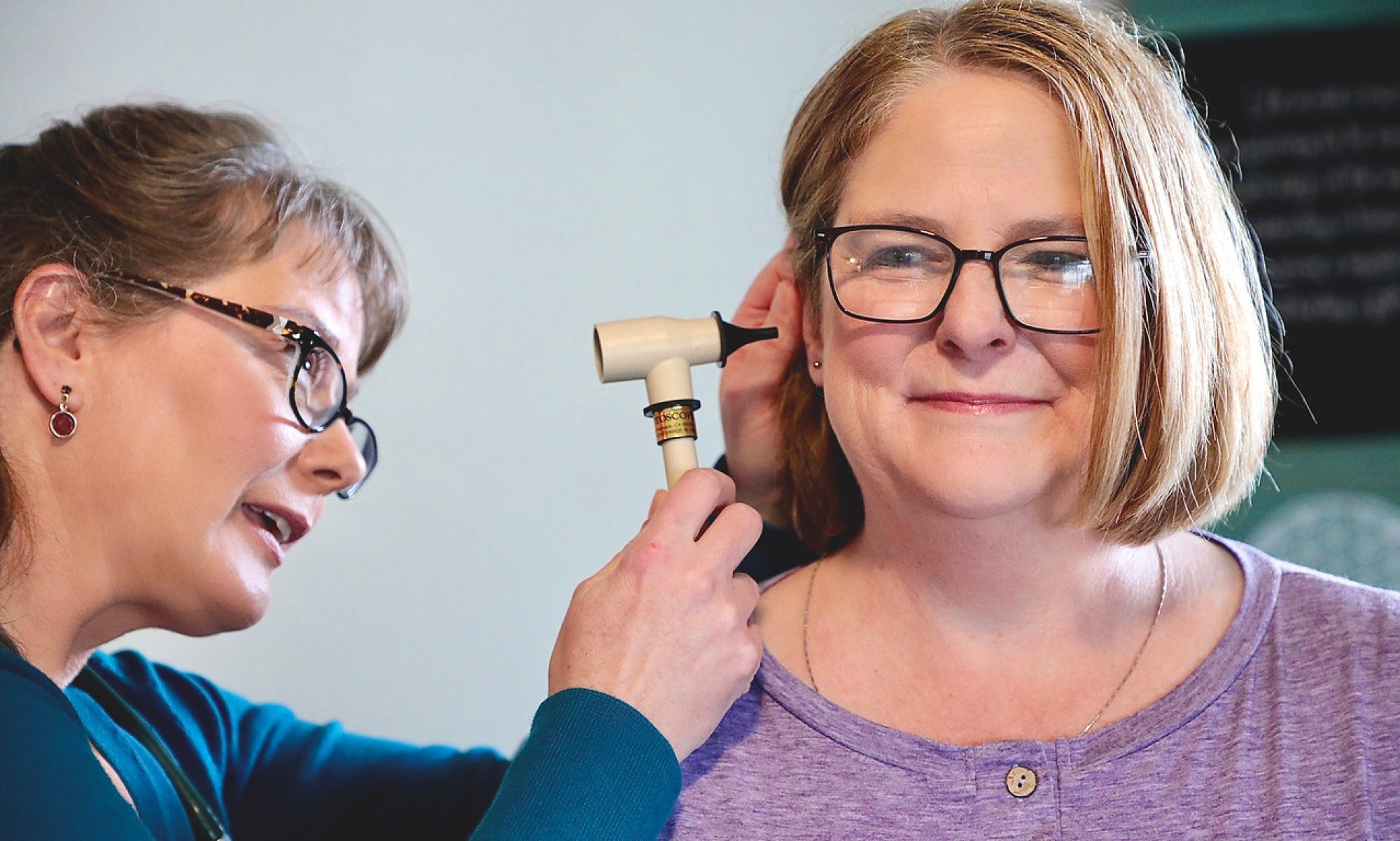 Andrea with patient checking ear